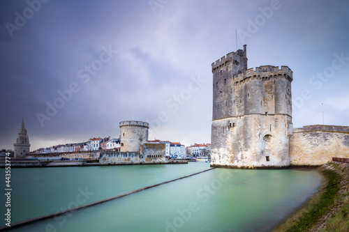 Storm over the entrance of the old harbor of La Rochelle in France, with the Tour de la Chaine on the left side and Tour Saint-Nicolas on the right side, Nouvelle Aquitaine region, France