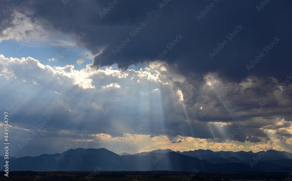 striking panorama of the front range of the colorado rocky mountains at dusk, as seen from broomfield, colorado