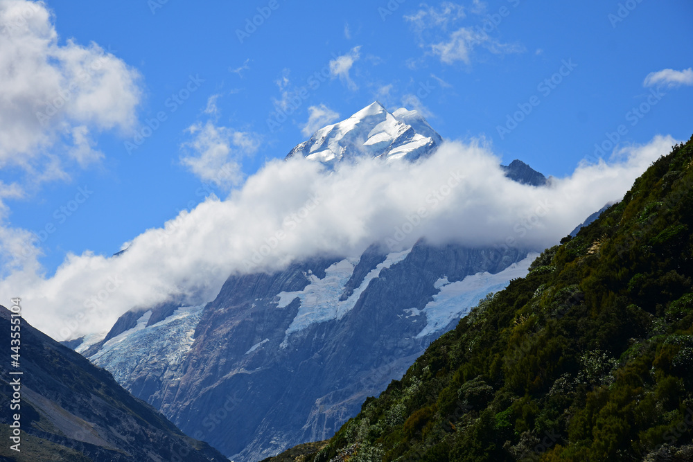 the rugged summit  of mount cook as seen from the hooker valley track near mount cook village on a sunny day in summer on the south island of new zealand
