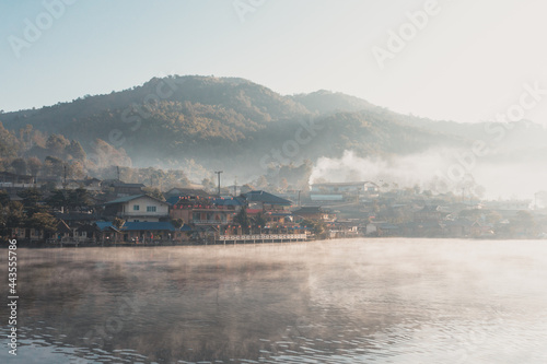 fog on the river with village background