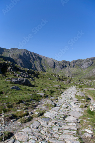 Stone mountain path trail at Cwm Idwal mountains, part of Snowdonia National Park, on a sunny day