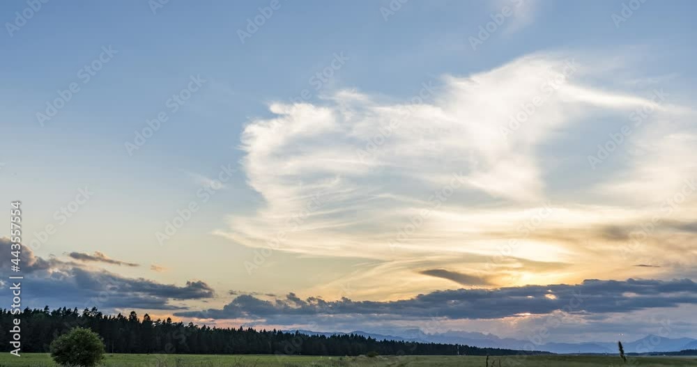 Time lapse of beautiful and colorful sunset over farming field. Grassland in the foreground. Alps in the distance. Pristine farmland in Slovenia. Right tracking, wide angle Time lapse of beautiful and colorful sunset over farming field. Grassland in the foreground. Alps in the distance. Pristine farmland in Slovenia. Right tracking, wide angle