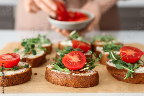 Tasty fresh toasts on table in kitchen, closeup