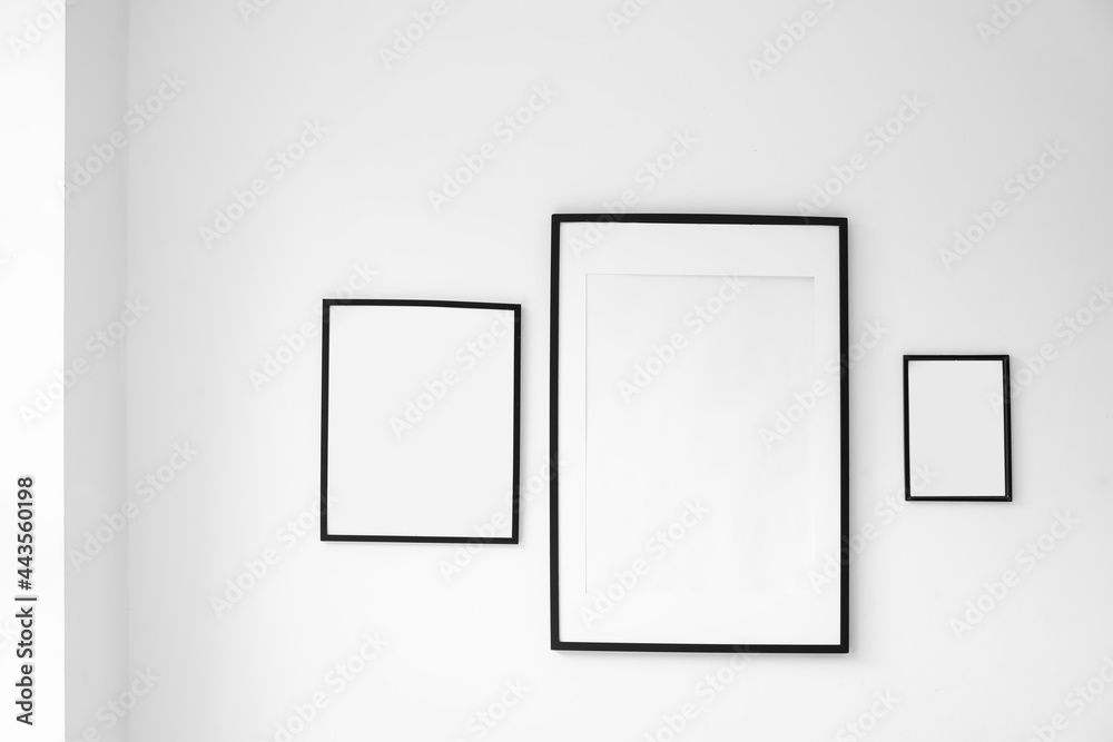 Blank photo frames hanging on wall