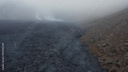 Freshly formed earth surface with black basalt rock in Iceland, cloudy photo