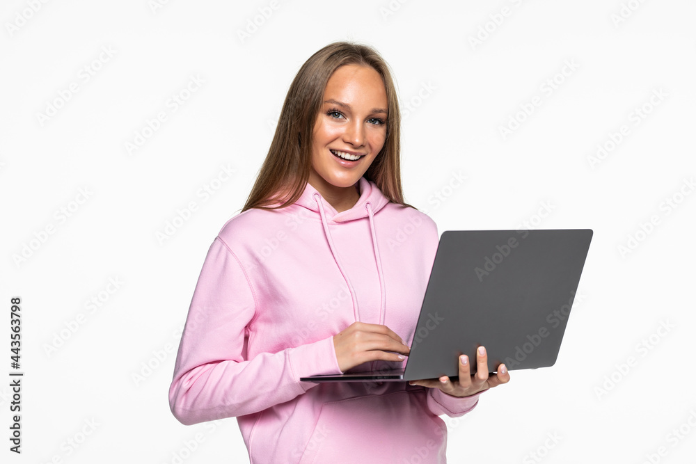 Young happy smiling woman holding laptop and sending email to her best friend Young happy smiling woman holding laptop and sending email to her best friend