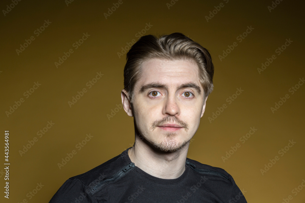 Portrait serious man on yellow background
Portrait serious man on yellow background