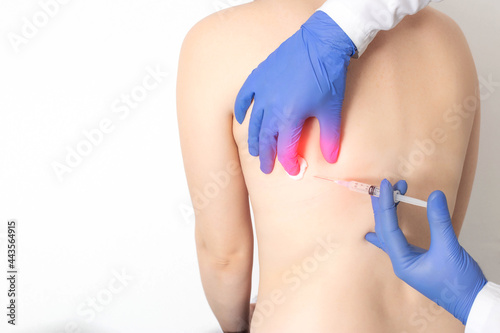 The doctor makes an injection with a medication blockade into the intercostal space in case of intercostal neuralgia. Pain in the ribs and side, copy space for text