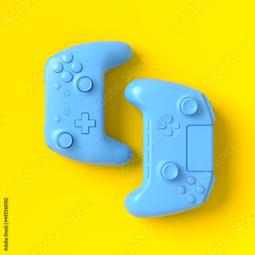 Set of lying gamer joysticks or gamepads on yellow background