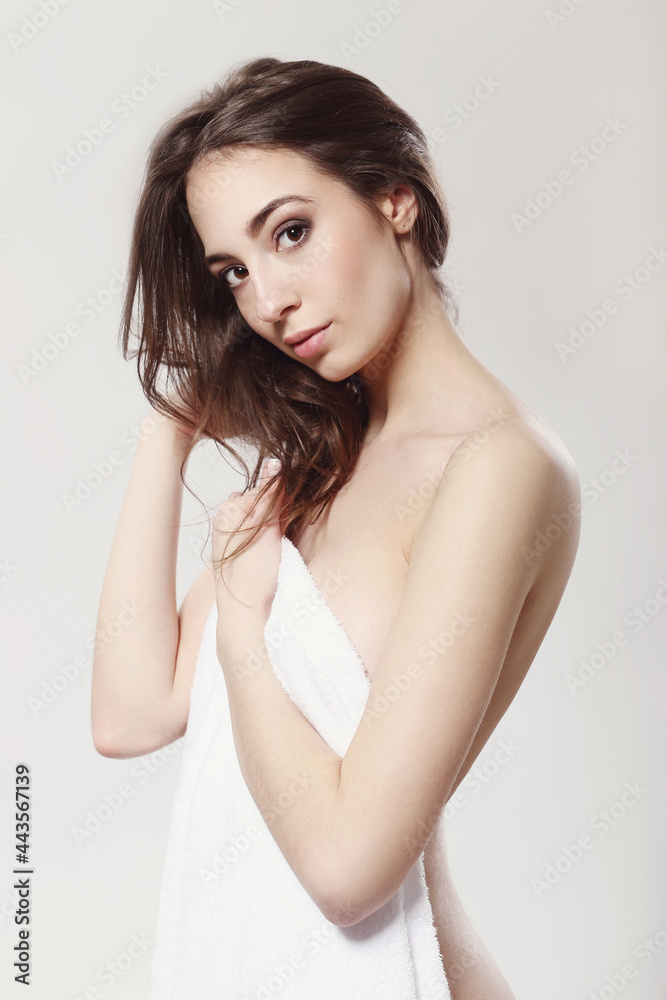 The beautiful girl is having a photo session in the studio in a night dress. The beautiful girl is having a photo session in the studio in a night dress.