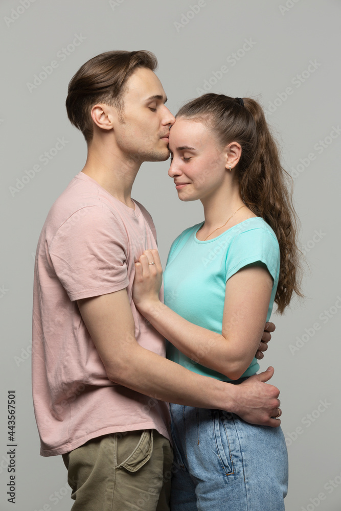 Studio portrait affectionate, tender young couple hugging
Studio portrait affectionate, tender young couple hugging