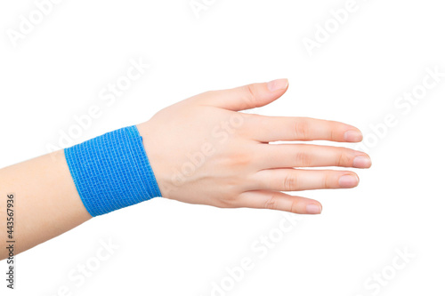 Blue elastic bandage on the wrist joint of the hand on a white background, isolate. Concept of wrist fixation in case of dislocation and contusion, compression