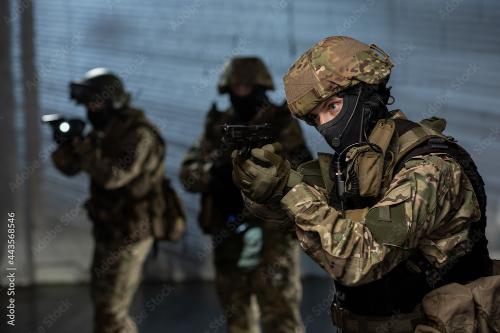 Military men with guns and lanterns coming after criminal Military men with guns and lanterns coming after criminal