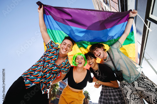 Smiling queer people celebrating pride together