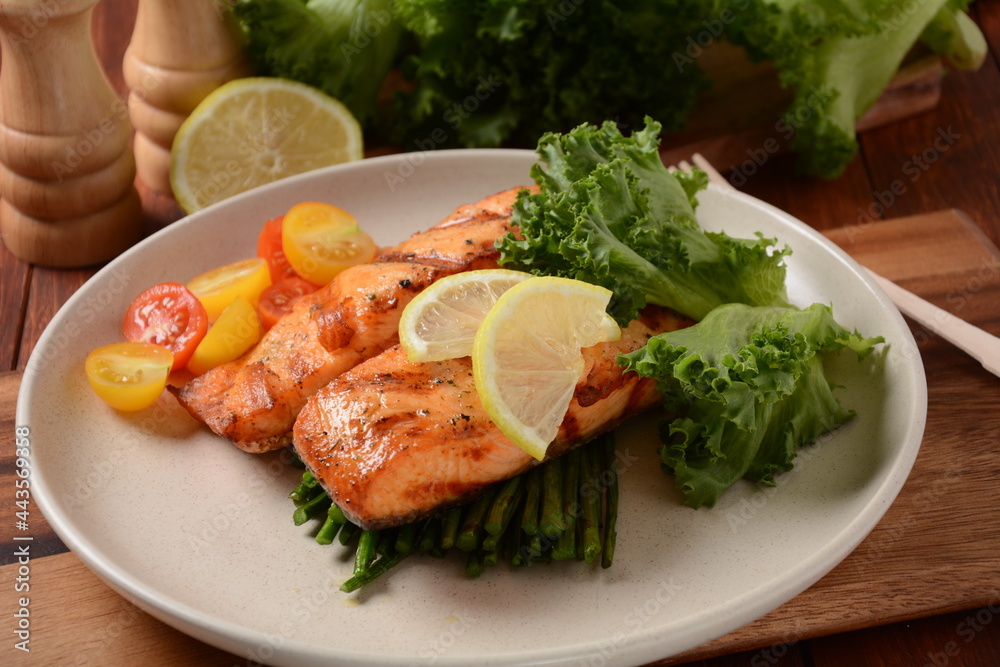 Fried salmon steaks. Cooked salmon steak with pepper, herbs, lemon, garlic, olive oil and Brussels sprouts. Grilled fresh fish. Fried salmon steaks. Cooked salmon steak with pepper, herbs, lemon, garlic, olive oil and Brussels sprouts. Grilled fresh fish.
