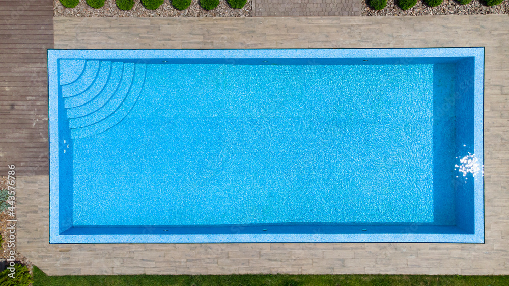 Aerial. Modern luxury pool with staircase. Top view from drone.