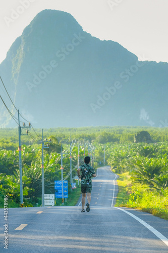 Happy traveler man enjoy Phang Nga bay view point, alone Tourist standing and relaxing at Samet Nang She, near Phuket in Southern Thailand. Southeast Asia travel, trip and summer vacation concept