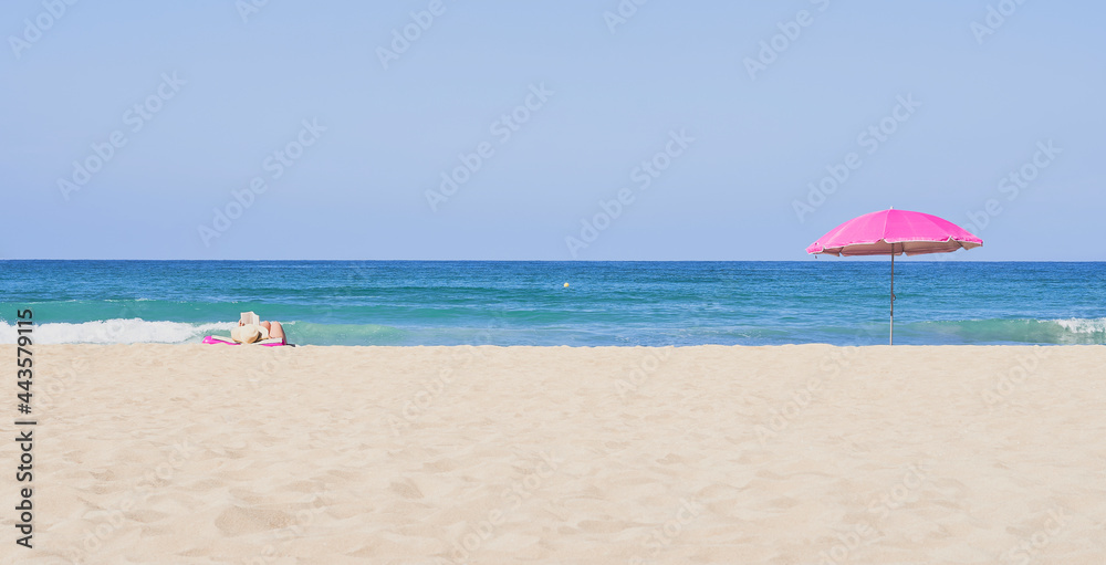 Summer concept. Two umbrellas, beach and blue sea on a beautiful sunny day