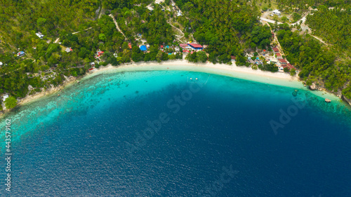 Aerial view of sandy beach on a tropical island with palm trees. Canibad beach, Philippines,Samal island.