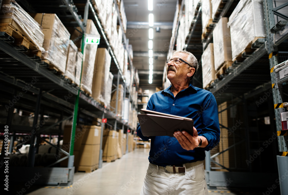 A caucasian warehouse manager checking stock inventory A caucasian warehouse manager checking stock inventory
