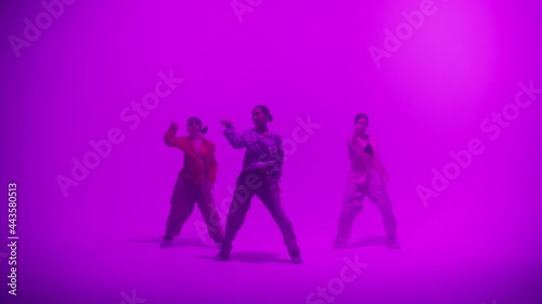 Wallpaper Mural Professional choreographers dancing on purple neon background in studio for dance video clip. Women dancers showing new movements. Advertising of modern dance school for teenagers. Torontodigital.ca