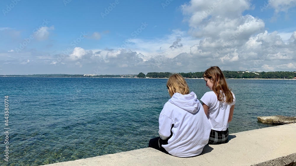 Young girls on vacation by the sea.