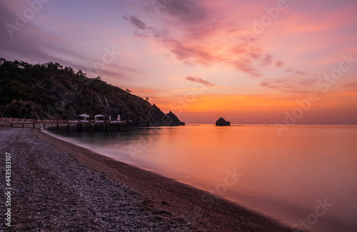 Picturesque Mediterranean seascape in Turkey. Colorful sunrise in a small bay near the Tekirova village, District of Kemer, Antalya Province. Long exposure photo.