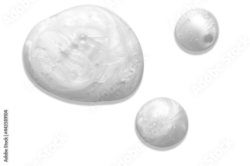 Pearly white thick creamy texture with bubbles. Soap or liquid cream with pearl colour on white background. Milky blobs.