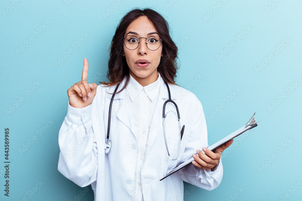 Young doctor mexican woman isolated on blue background having some great idea, concept of creativity. Young doctor mexican woman isolated on blue background having some great idea, concept of creativity.