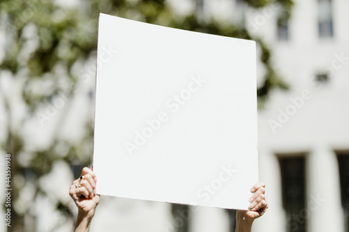 Woman holding a white placard with copy space at the black lives matter protest