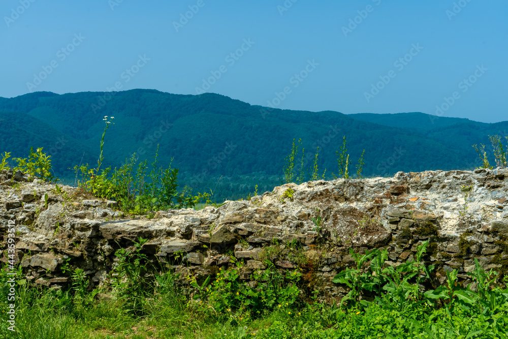 KHUST, UKRAINE - June 24, 2021: Ruins of Khust castle which was built as a fortress to protect the salt road from Solotvyno in Khust, Ukraine on June 24, 2021.
