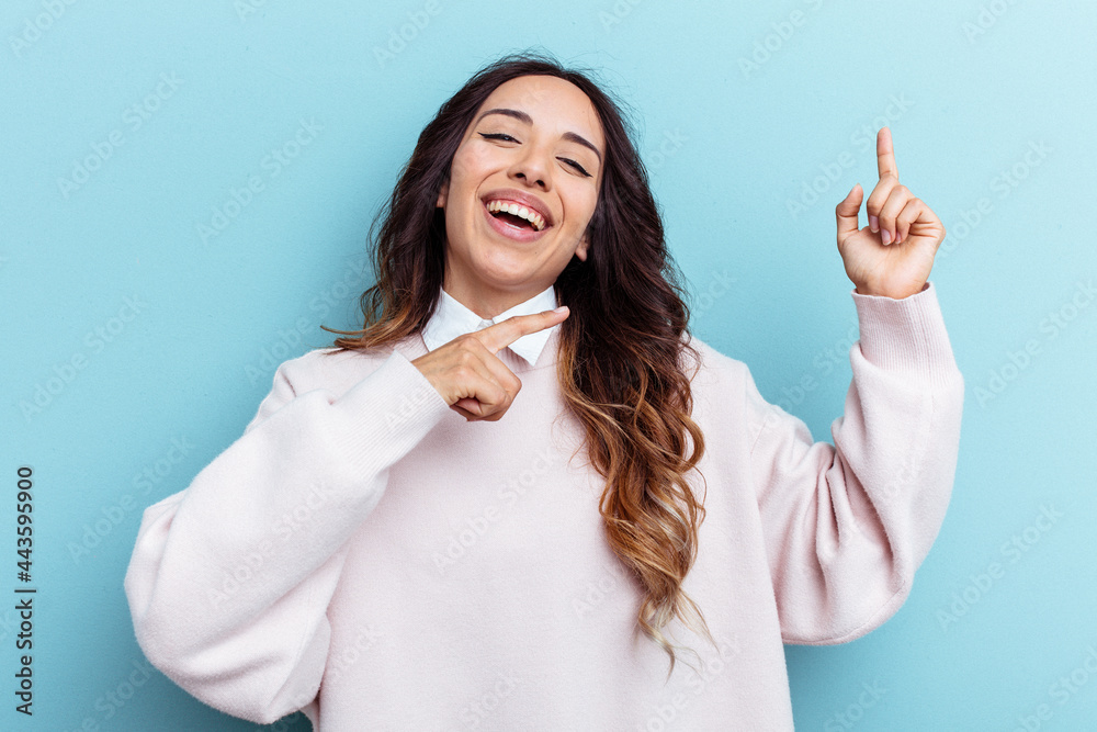 Young mexican woman isolated on blue background dancing and having fun. Young mexican woman isolated on blue background dancing and having fun.