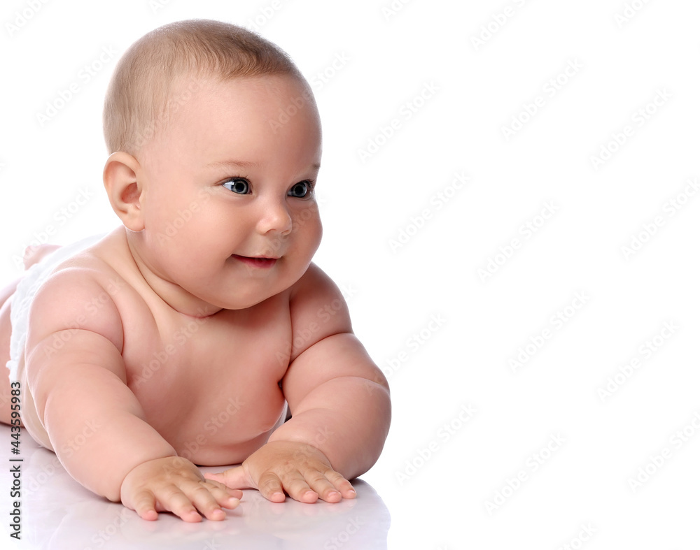 Portrait of happy infant child baby girl kid in diaper lying on her tummy, stomach looking aside at copy space isolated on a white background Portrait of happy infant child baby girl kid in diaper lying on her tummy, stomach looking aside at copy space isolated on a white background