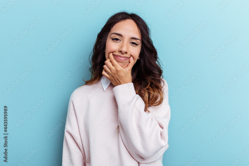 Young mexican woman isolated on blue background doubting between two options. Young mexican woman isolated on blue background doubting between two options.