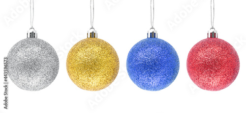 Hanging silver, golden, blue, red glitter Christmas baubles isolated a on white background.