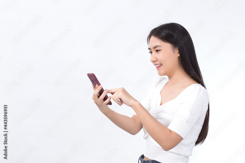 Portrait of beautiful asian girl Use the smartphone happily on a white background Portrait of beautiful asian girl Use the smartphone happily on a white background