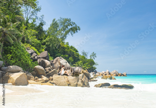 Beaitiful girl on a bouldrer in the Seychelles