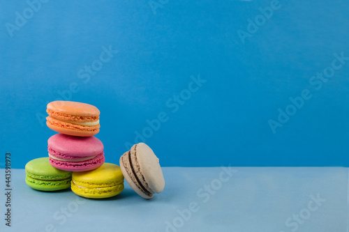 Multicolored macaroons on a blue background