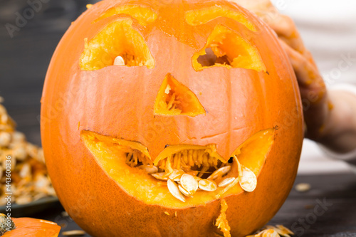 preparing a scary orange pumpkin lamp