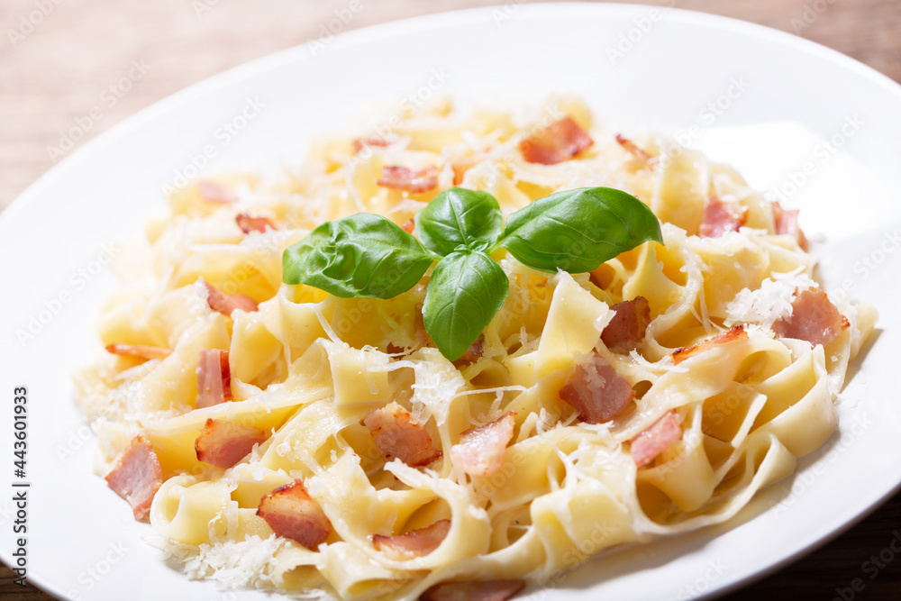 plate of pasta carbonara with basil plate of pasta carbonara with basil