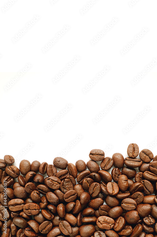Fototapeta premium Pile of roasted coffee beans on white background with free space for text and design