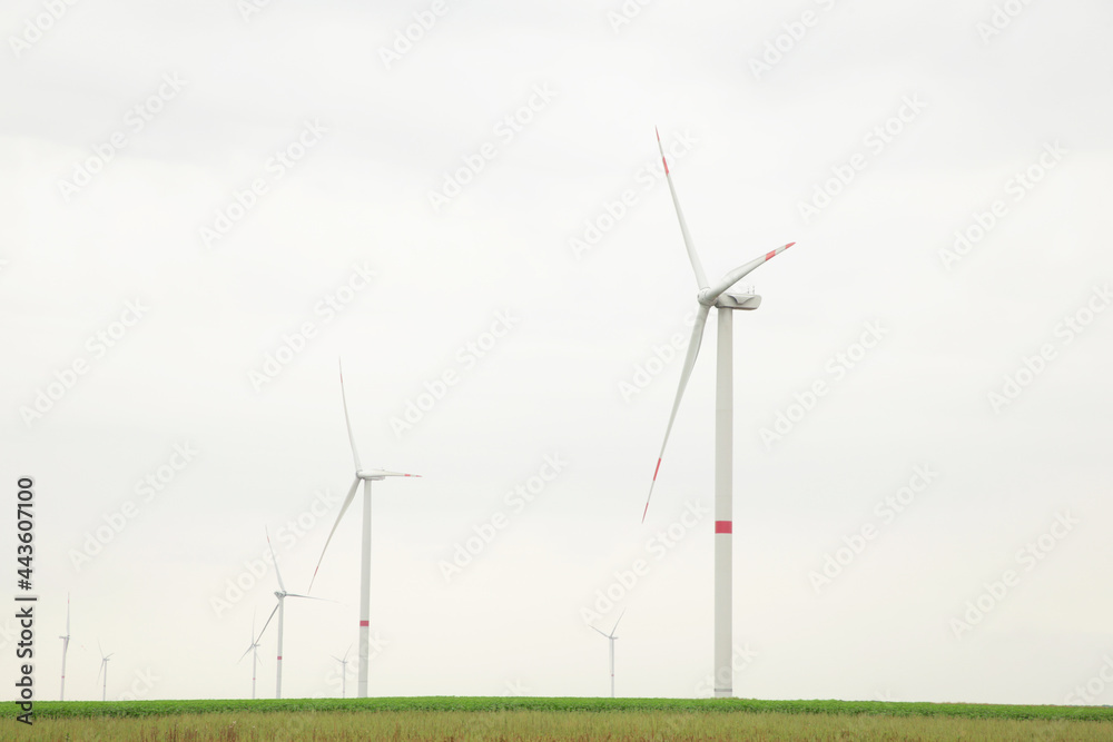 Windmills for electric power production on a cloudy day Windmills for electric power production on a cloudy day