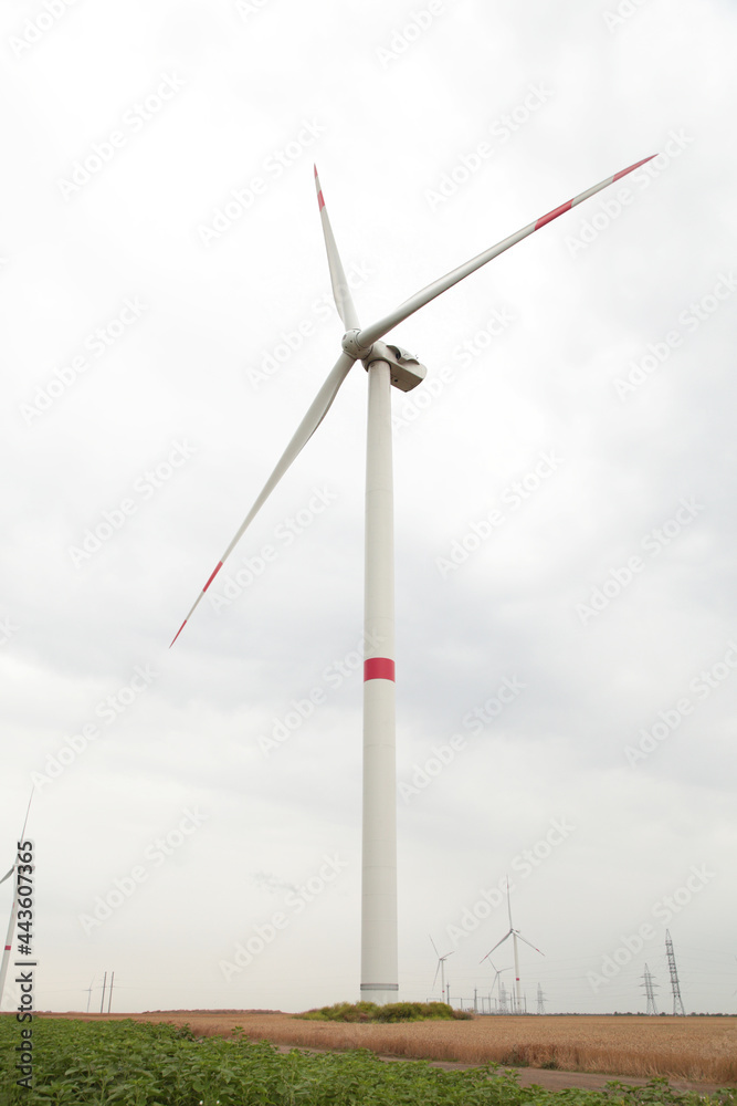 Windmills for electric power production on a cloudy day Windmills for electric power production on a cloudy day