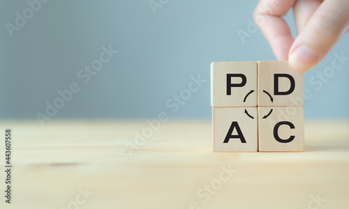 Plan do check action concept , PDCA on wooden cube block with grey background ;copy space. Deming cycle concept business management method to control and continuous improvement of process and product