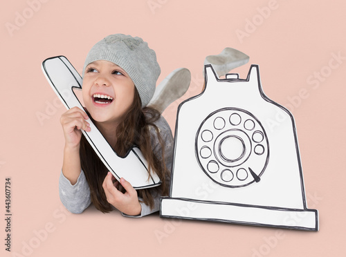 Tableau sur toile Little girl playing pretend with a paper phone