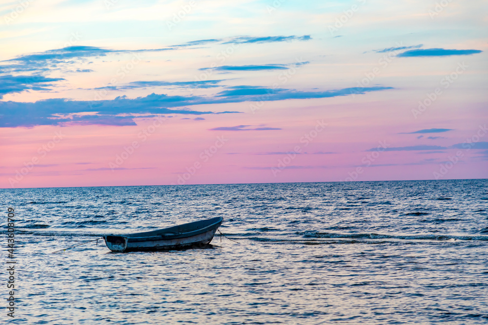 Fototapeta premium Sunset beach in baltic sea with boat
