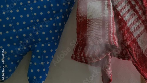 Steam from kettle and saucepans against the kitchen potholders and kitchen towels photo