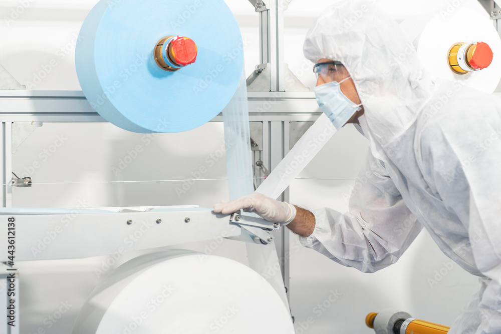 Production line workers and experts control the production of raw fabrics to produce quality masks in the factory. Production line workers and experts control the production of raw fabrics to produce quality masks in the factory.