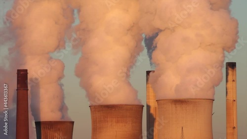 steam rising from the cooling towers of a lignite-fired powerplant photo
