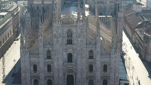 Aerial drone footage view of sunrise of famous statue on cathedral Duomo in Milan Italy  // no video editing
